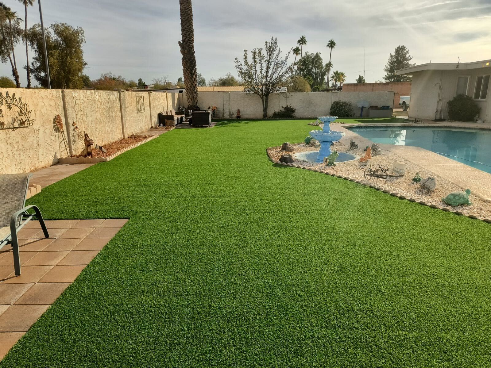 Backyard pool area with artificial turf Arizona